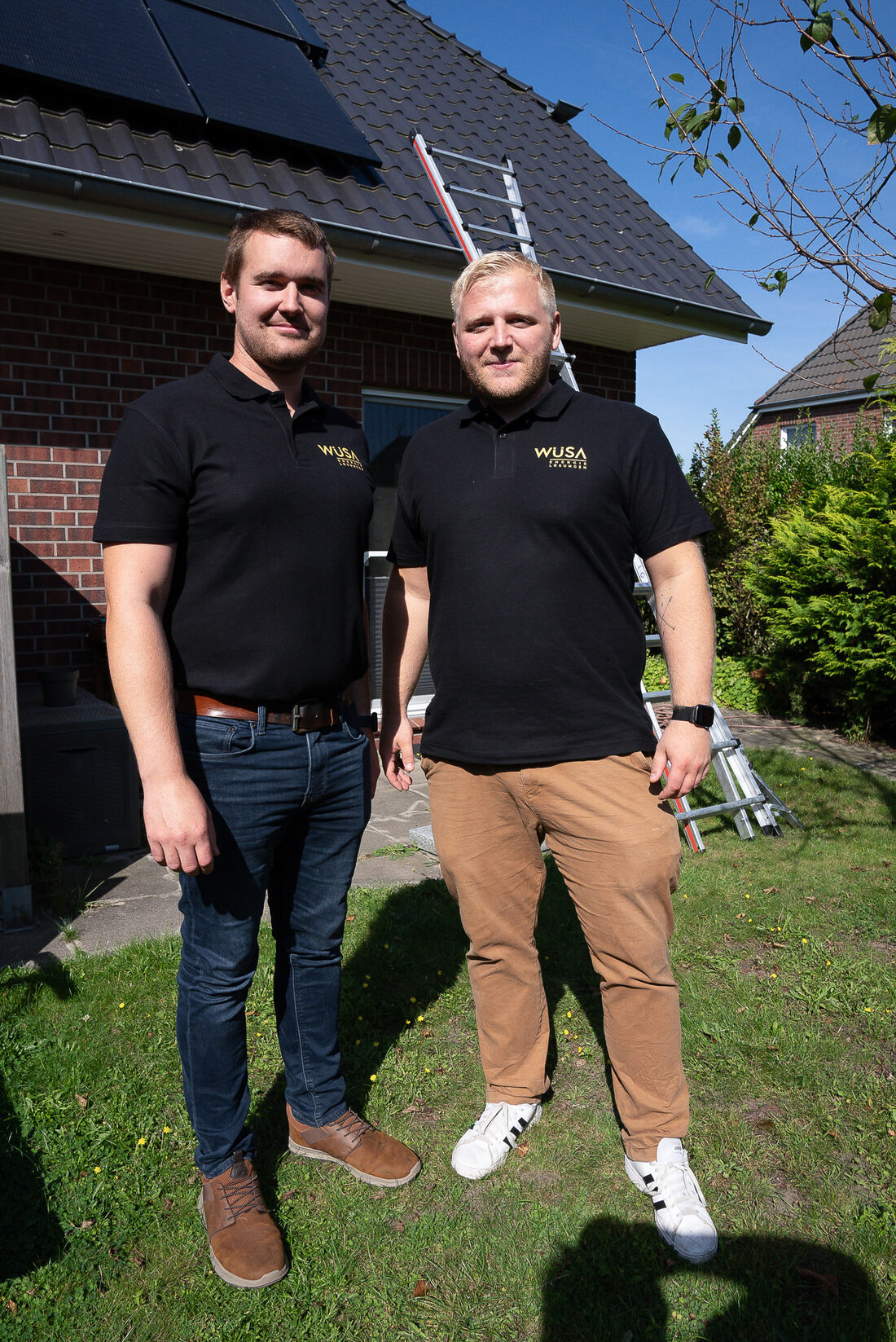 Team vor einem Haus mit PV-Anlage